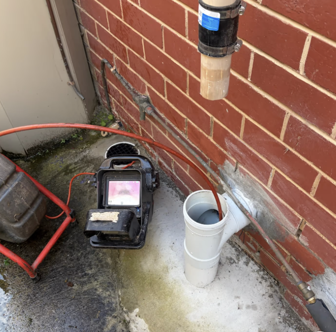 H2PRO plumber using a CCTV drain camera to inspect a blocked drain in Donvale