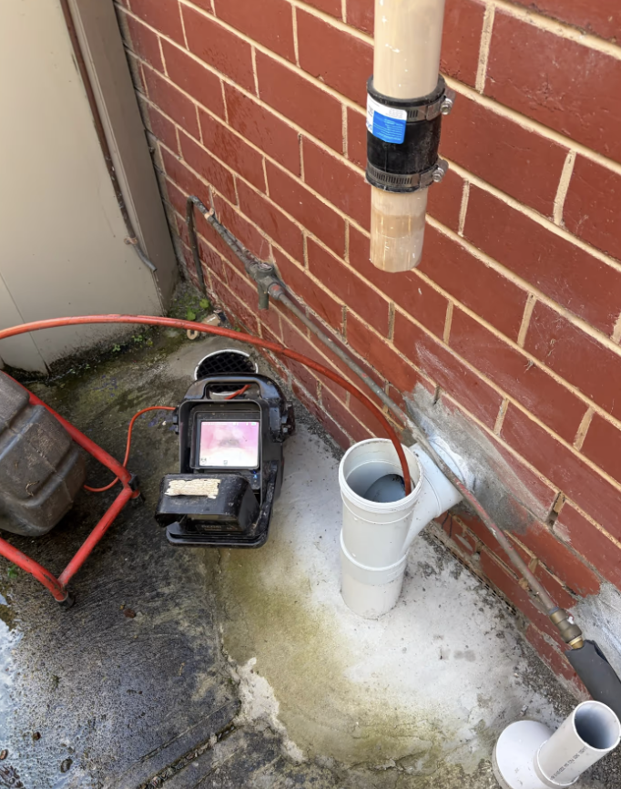 H2PRO plumber using a CCTV drain camera to inspect a blocked drain in Donvale