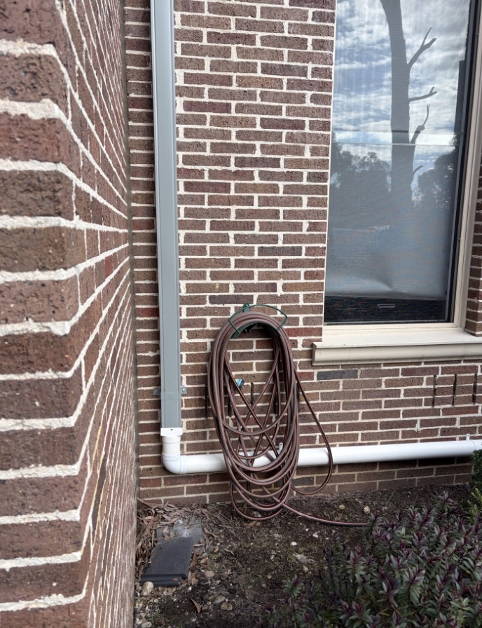 Downpipe connected to stormwater drainage system at a Park Orchards home