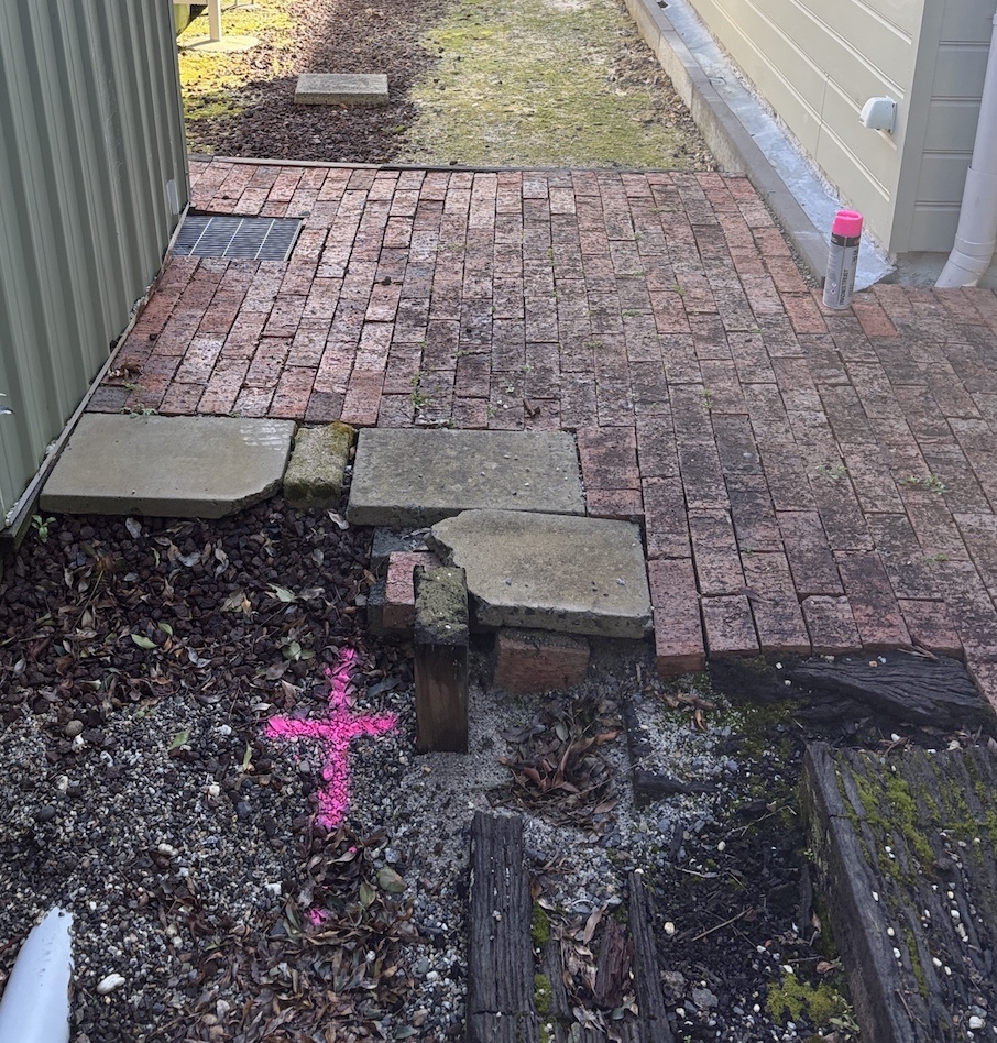 Old brick paving marked to show stormwater pipe location in Ringwood